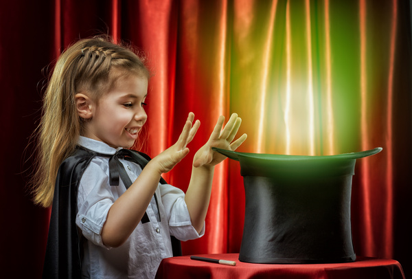 Little girl playing magic Stock Photo