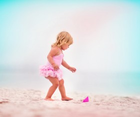 Little girl playing on the beach Stock Photo
