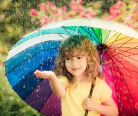 Little girl playing outdoors on rainy day Stock Photo 01