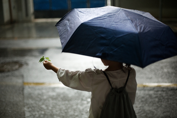 Little girl playing outdoors on rainy day Stock Photo 02
