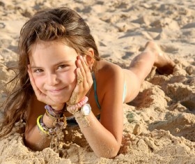 Lying on the beach little girl Stock Photo