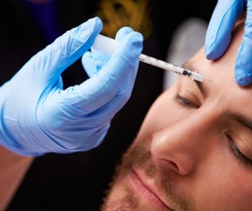 Male forehead botulinum injection Stock Photo