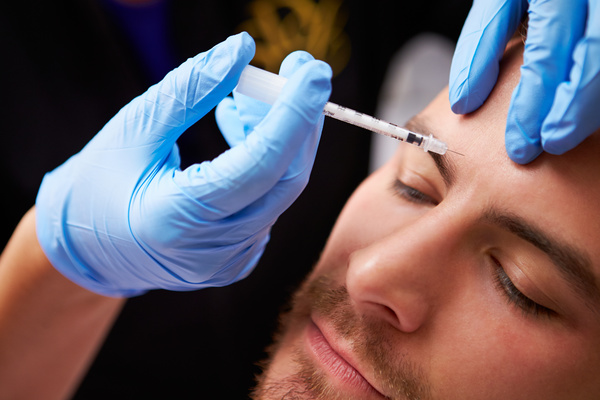 Male forehead botulinum injection Stock Photo
