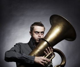 Man blowing brass instruments Stock Photo