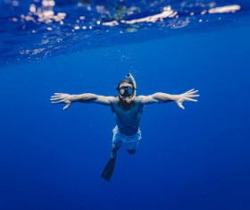 Man diving in sea with snorkel Stock Photo