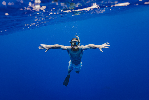 Man diving in sea with snorkel Stock Photo