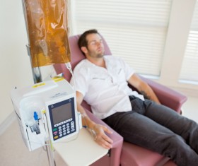 Man lying in sofa on infusion Stock Photo