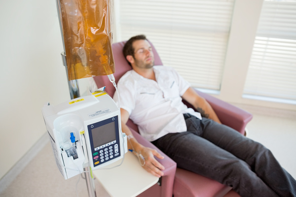 Man lying in sofa on infusion Stock Photo