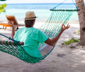 Man meditating in hammock Stock Photo