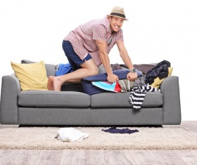 Man preparing clothes for travel Stock Photo