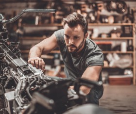 Man repairing motorcycle Stock Photo 01