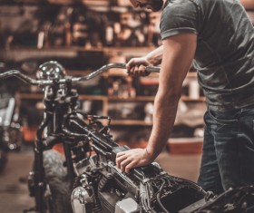 Man repairing motorcycle Stock Photo 02