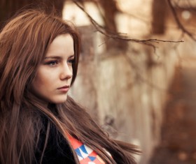 Melancholy girl against the wall Stock Photo