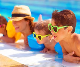 Mom with children playing in the pool Stock Photo