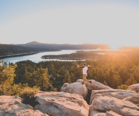 On the hill excited jumping man Stock Photo