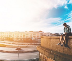 People sitting outside high-rise buildings Stock Photo