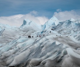 People traveling on the snowy mountains Stock Photo