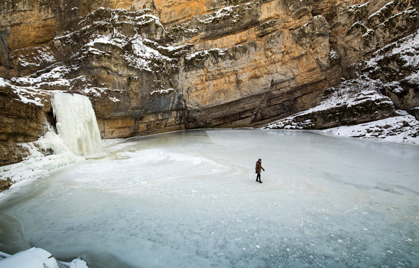 People walking on frozen river Stock Photo