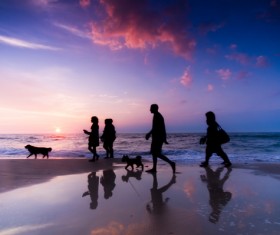 People walking on the beach Stock Photo