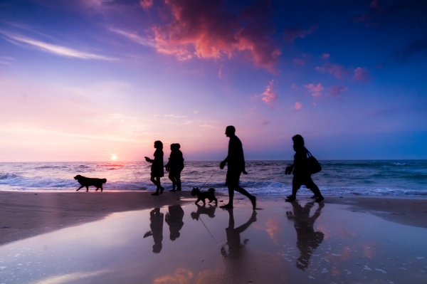 People walking on the beach Stock Photo