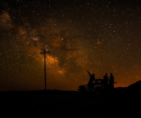 People watching sparkling starry sky at night Stock Photo