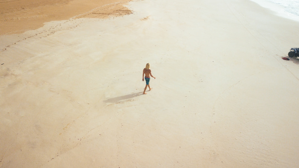 Person walking on empty seaside Stock Photo