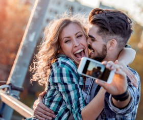 Romantic couple using smart phone selfie Stock Photo 01