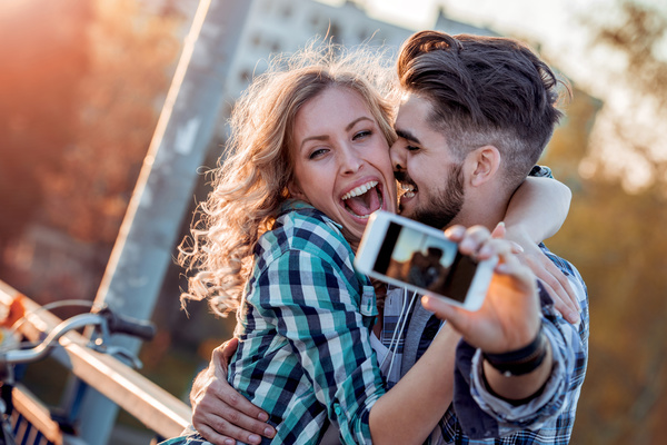 Romantic couple using smart phone selfie Stock Photo 01