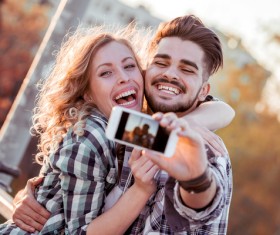 Romantic couple using smart phone selfie Stock Photo 02