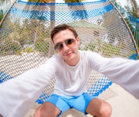 Sitting on hammock men selfie Stock Photo
