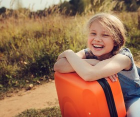 Smiling little girl and luggage Stock Photo