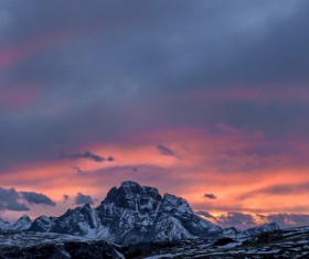 Snowy rocky mountain peak at sunset Stock Photo