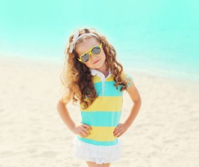 Standing on the beach taking pictures little girl Stock Photo