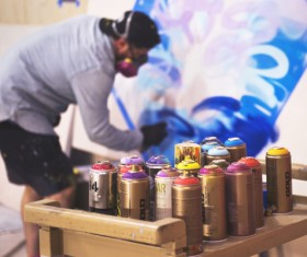 Street graffiti and paint bottles Stock Photo