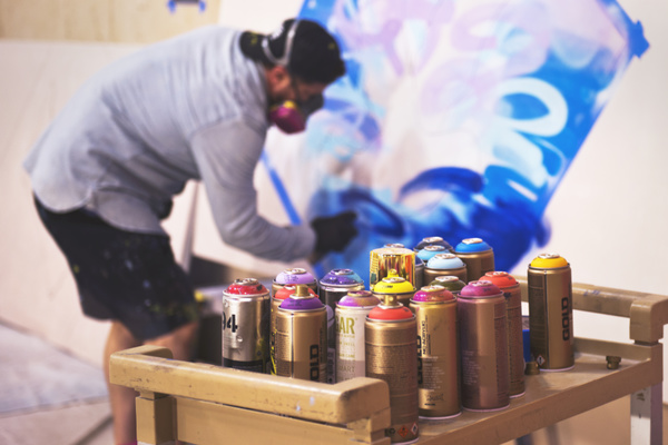 Street graffiti and paint bottles Stock Photo