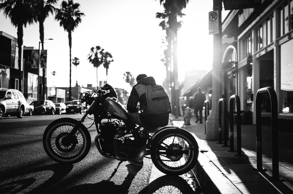 Street young man sitting on a motorcycle Stock Photo