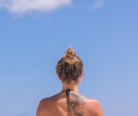 Stylish woman with tattoo on back Stock Photo