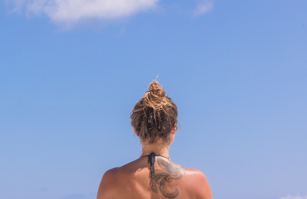 Stylish woman with tattoo on back Stock Photo