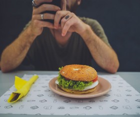 The use of smart phones shooting hamburger man Stock Photo