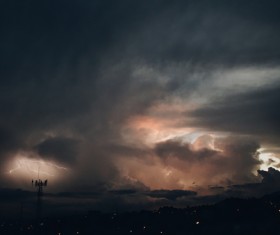 Thunder bolts and black clouds at dusk Stock Photo