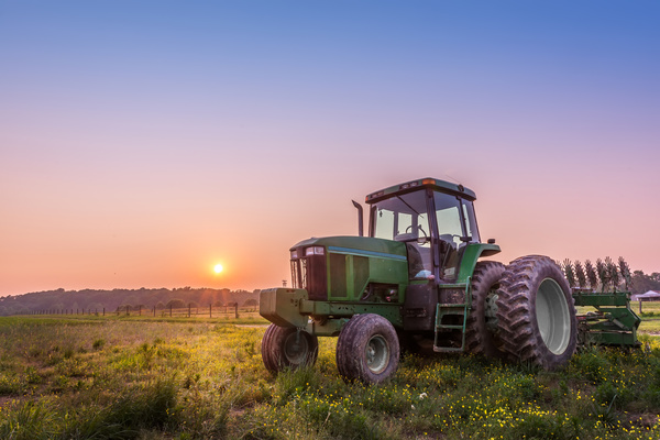 Tractor parked in the farmland Stock Photo