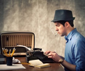 Use old-fashioned typewriter typing man Stock Photo