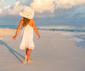 Walking on the beach little girl Stock Photo