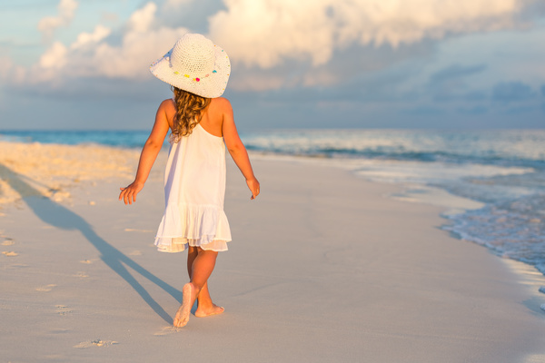 Walking on the beach little girl Stock Photo
