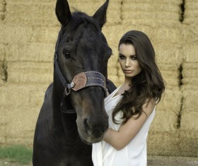 Woman and black horse Stock Photo