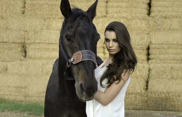 Woman and black horse Stock Photo