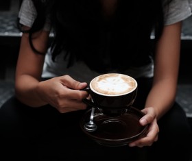 Woman drinking coffee sitting on the steps Stock Photo