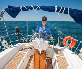 Woman driving a yacht Stock Photo