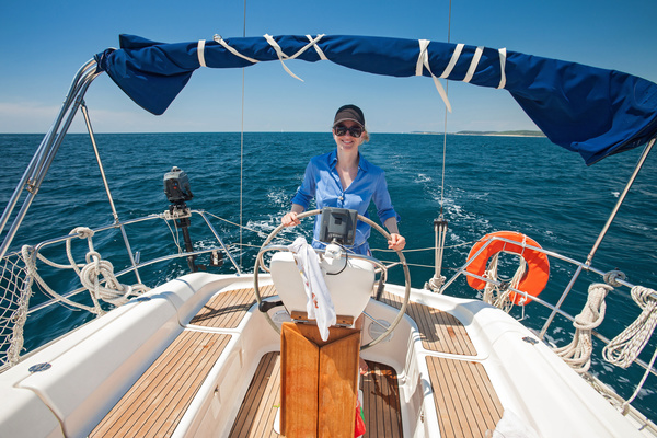 Woman driving a yacht Stock Photo