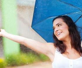 Woman having fun with umbrella on rainy day Stock Photo 02